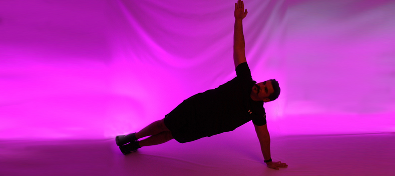 Man doing side plank in light therapy room