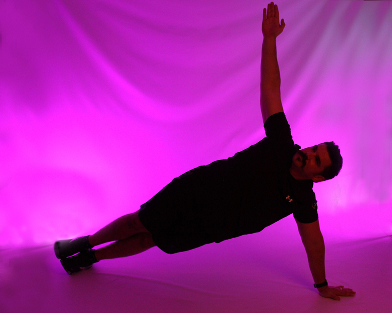 Man doing side plank with light therapy