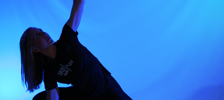 Woman stretching with blue lighting